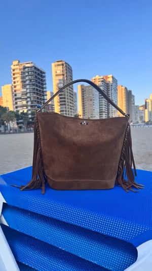 Bag Rising from the Sand in a fake-out-of-home ad of Sandro Paris