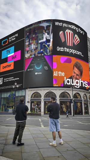 Man Grabs Popcorn from Digital Screen in a fake-out-of-home ad of Samsung
