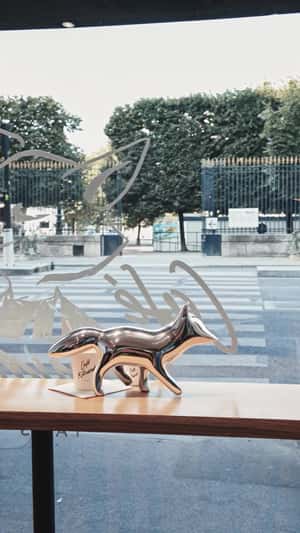 Silver Fox Spills Coffee Cup in a fake-out-of-home ad of Maison Kitsune