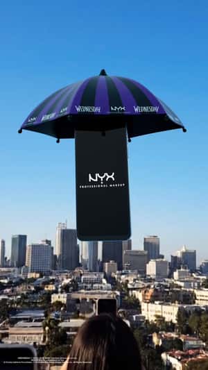 Smartphone Descends with Umbrella in a fake-out-of-home ad of NYX Cosmetics