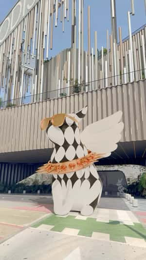 Winged Cat Sculpture in a fake-out-of-home ad of El Club