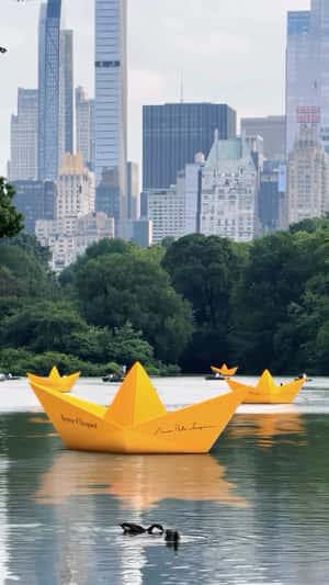 Yellow Paper Boats in a fake-out-of-home ad of Veuve Clicquot