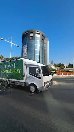 Truck Loaded with Tennis Balls in a fake-out-of-home ad of Green Padel Club