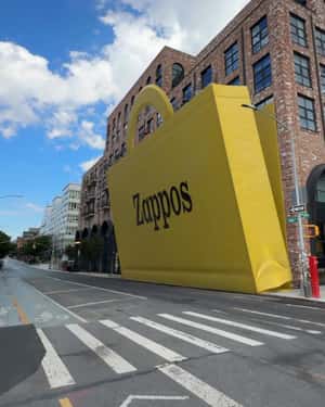 Yellow Paper Bag Reveals Footwear in a fake-out-of-home ad of Zappos