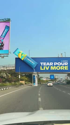 Hydrating Powder Pours on Bottled Water in a fake-out-of-home ad of Liquid I.V.