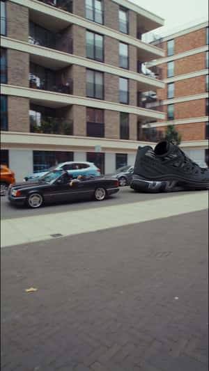 Giant Shoe Pulled by Car in a fake-out-of-home ad of Foot Locker