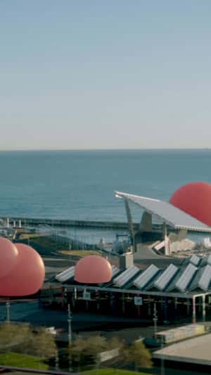 Giant Pink Balloons Float Over Skyline in fake-out-of-home ad of Pull&Bear