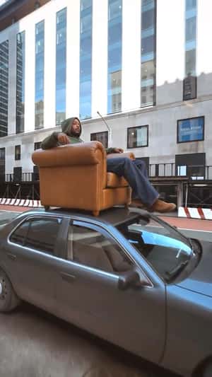 Man on Couch on Car Roof in a fake-out-of-home ad of House of Pezzo