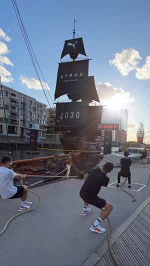 Black Sailboat in Waterfront Dock in a fake-out-of-home ad of PUMA x Hyrox