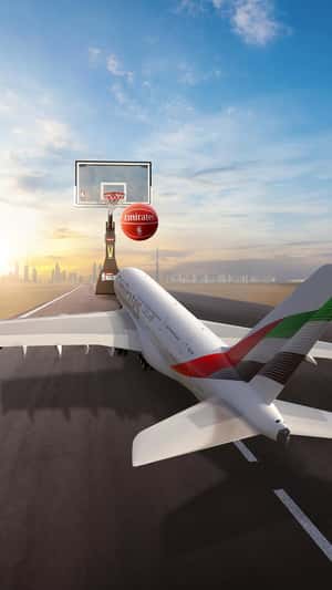 Airplane Shoots Basketball in Hoop in a fake-out-of-home ad of Emirates