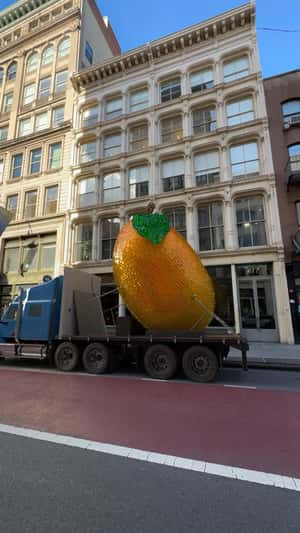 MGiant Glittering Mango Sculpture Rolls Through Soho in a fake-out-of-home ad of Mango