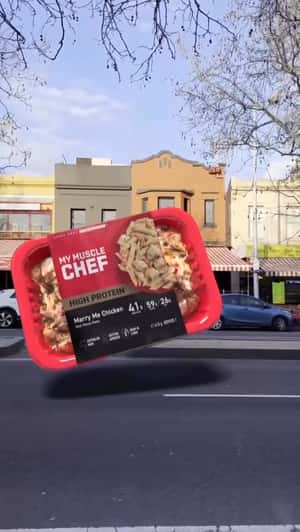 Giant Chicken Meal Pops Out of Phone in a fake-out-of-home ad of My Muscle Chef