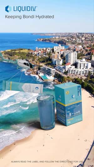 Giant Glass on Bondi Beach in a fake-out-of-home ad of Liquid I.V.
