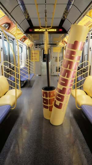 Giant Mascara Inflated Inside Train in a fake-out-of-home ad of Maybelline