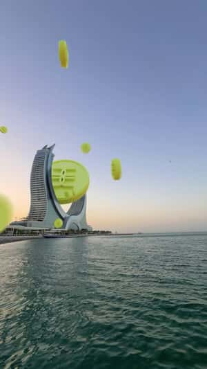 Giant Coin Lands on Katara Towers in a fake-out-of-home ad of Gold Apple