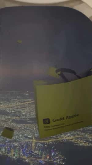 Giant Bags Float Over Doha in a fake-out-of-home ad of Gold Apple