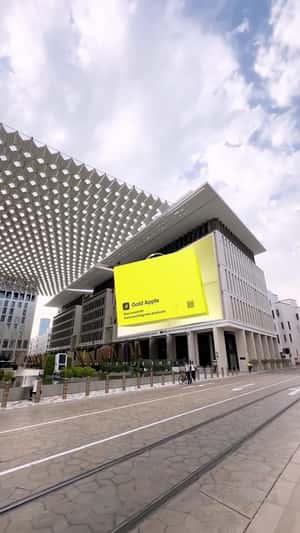 Giant Bag Emerges from Facade in a fake-out-of-home ad of Gold Apple