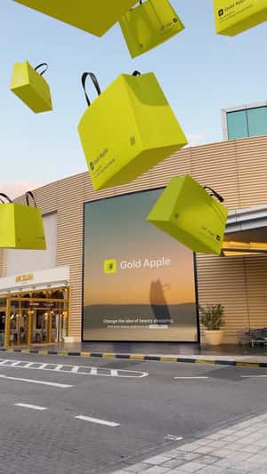 Giant Bags Burst from Billboard in a fake-out-of-home ad of  Gold Apple