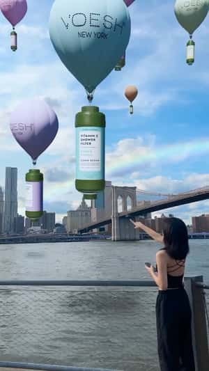 Giant Voesh Bottles Carried by Balloons in a fake-out-of-home ad of Sachane