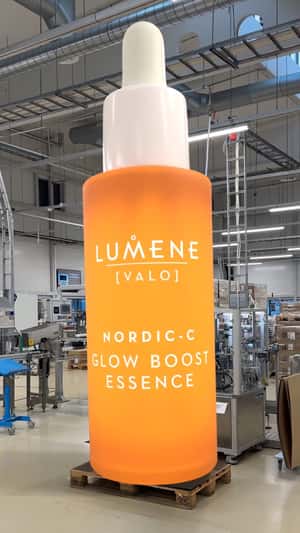 Giant Bottle Revelation in Factory in a fake-out-of-home ad of Lumene