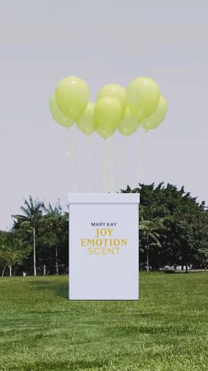 Giant Box Reveals Perfume in Field in a fake-out-of-home ad of Mary Kay