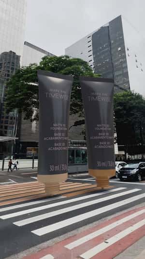 Giant Foundation Tubes Crossing Street in a fake-out-of-home ad of Mary Kay