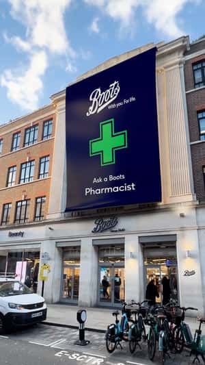 Giant Banner Unveiled at Store Facade in a fake-out-of-home ad of Boots