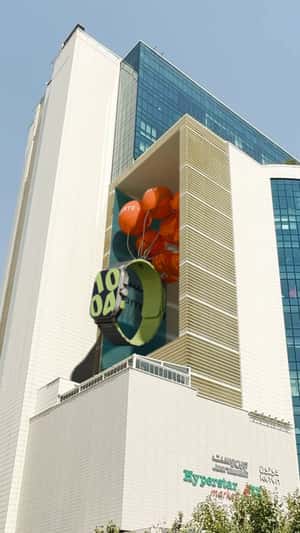 Massive Watch Emerges from Facade in a fake-out-of-home ad of Hamrahnasl