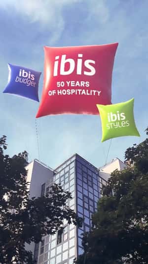 Floating Throw Pillows Above Paris in fake-out-of-home ad of Ibis Hotels