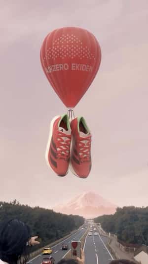 Giant Shoes Carried by Hot Air Balloon in a fake-out-of-home ad of Adidas