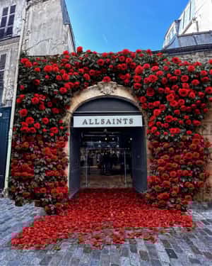 Storefront with Lush Roses Display in a fake-out-of-home ad of AllSaints