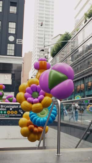 Flower Balloons Emerge from Subway Entrance in a fake-out-of-home ad of Bloomingdale's 