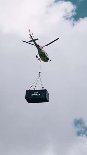 Giant Box Airlifted by Helicopter in a fake-out-of-home ad of Gloryfy