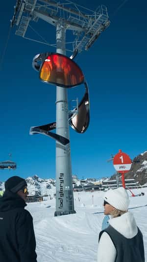 Giant Sunglasses Spiral Down Ski Lift Tower in a fake-out-of-home ad of Gloryfy