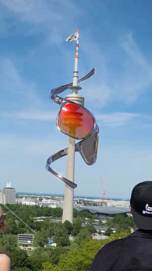 Massive Sunglasses Spiral on Olympic Tower in a fake-out-of-home ad of Gloryfy