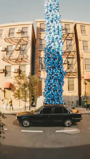 Towering Shoeboxes on Car Roof in a fake-out-of-home ad of JD Sports