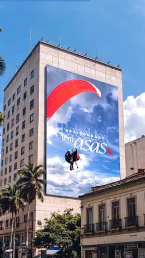 Paragliders Emerge from Billboard in a fake-out-of-home ad of Reserva