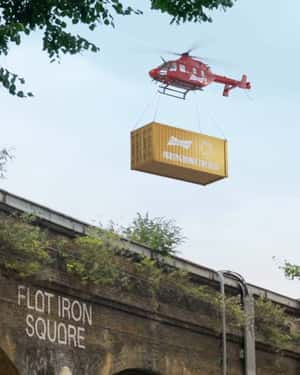 Helicopter Airlifts Boxcar over Flat Iron Square in a fake-out-of-home ad of Budweiser