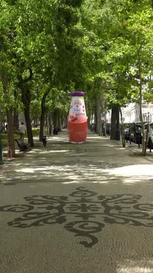 Giant Bottle on Avenida das Tilias in a fake-out-of-home ad of Compal