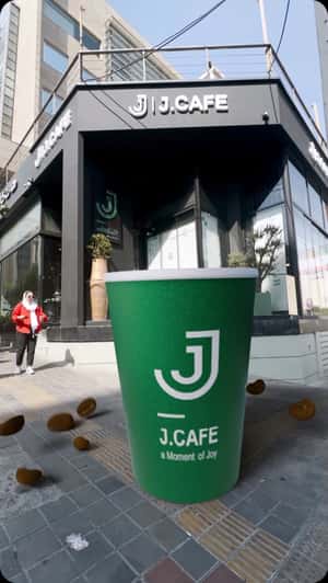 Giant Coffee Cup Falls from Above in a fake-out-of-home ad of J.Cafe 