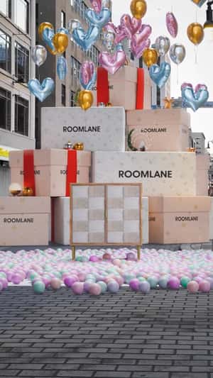 Giant Gift Box Reveal Bar Unit in a fake-out-of-home ad of Roomlane