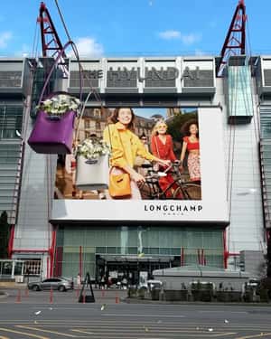 Giant Longchamp Bags Enter Billboard in a fake-out-of-home ad of Vogue