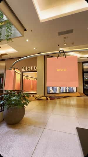 Giant Shopping Bags Glide to Store in a fake-out-of-home ad of MIxed