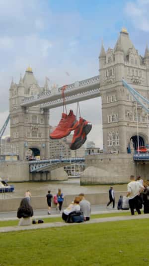 Giant Shoes Hanging on Tower Bridge in a fake-out-of-home ad of Adidas