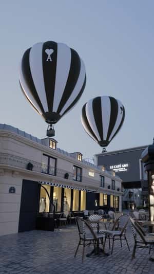 Black and White Hot Air Balloons Float Above Cafe in a fake-out-of-home ad of AMI