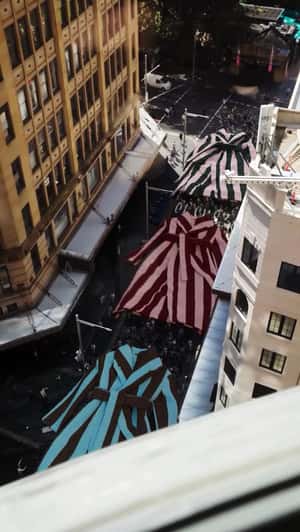 Giant Robes Float Above Crowds in a fake-out-of-home ad of Hommey 