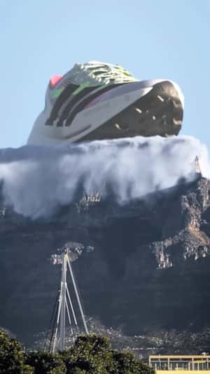 Giant "TERREX" Shoe Rise on Table Mountain in a fake-out-of-home ad of Adidas