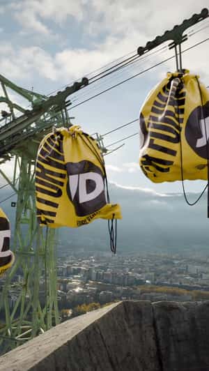 Giant Bags Glide Across Cables in a fake-out-of-home ad of JD Sports 
