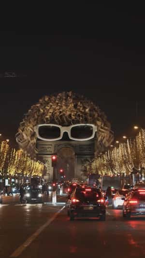 Giant Glasses and Wig at Arc de Triomphe in a fake-out-of-home ad of Michel Polnareff 