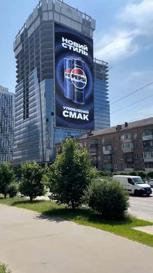 Giant Can on Car Emerges from Billboard in a fake-out-of-home ad of Pepsi